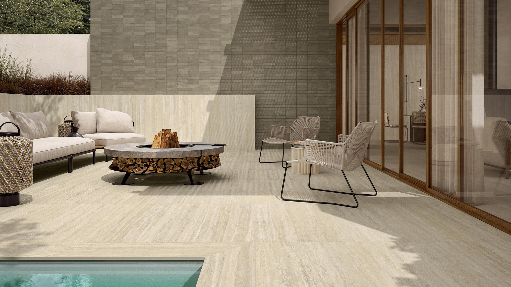 Living room with central fireplace, wood-effect flooring, marble-effect cladding, leather and fabric seating, wooden furnishings, and large windows overlooking the greenery.