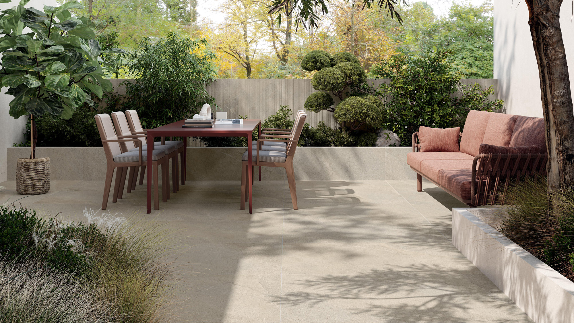 Outdoor terrace with stone‑effect porcelain flooring and dining table.