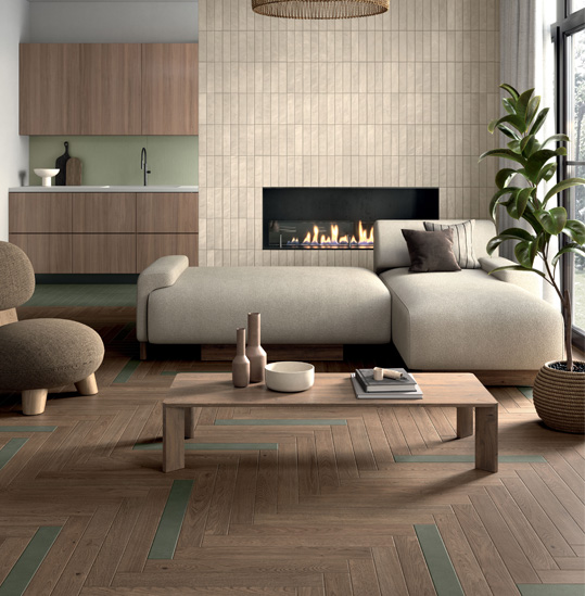 Living room with wood-effect stoneware flooring and green inserts, modern fireplace, corner sofa and beige relief tile wall.