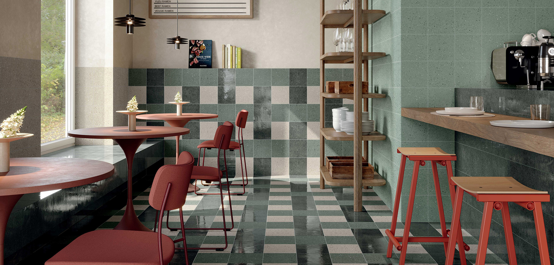 Bistro interior with TerraSale tiles in shades of green and beige, wooden and red metal furnishings, round tables and tiled walls.