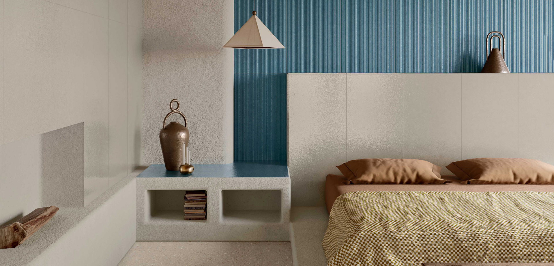 Bedroom with beige and blue ceramic wall tiles, bed with checked blanket and terracotta details, decorative vases and books on display.