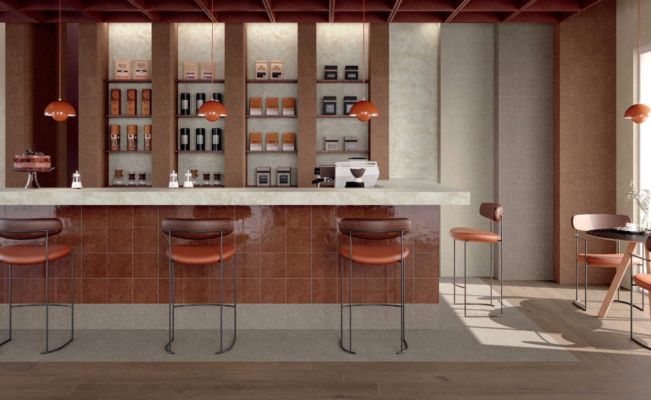 Warm-toned café interior with Marca Corona Terrasale tiles in red lacquer.