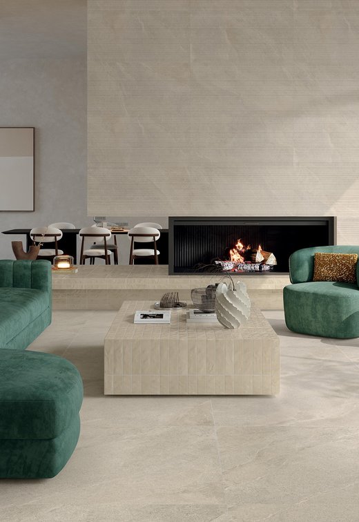 Salon moderne avec sol effet pierre claire et canapé vert.