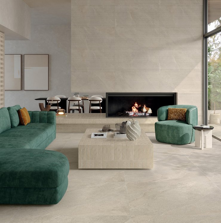 Modern living room with light stone‑effect porcelain floor and green sofa.