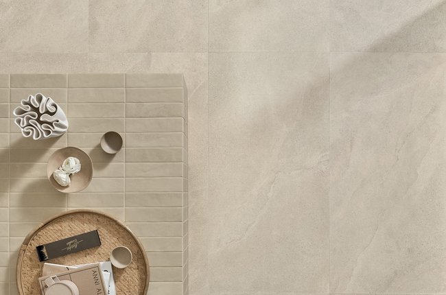 Top view of stone‑effect porcelain floor with coffee table and decorative objects.