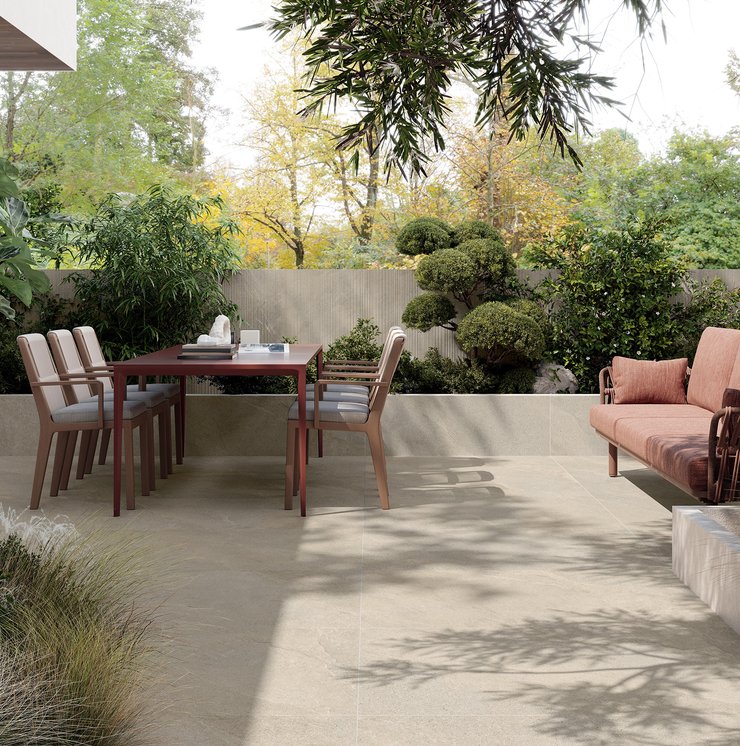 Outdoor terrace with stone‑effect porcelain flooring and dining table.