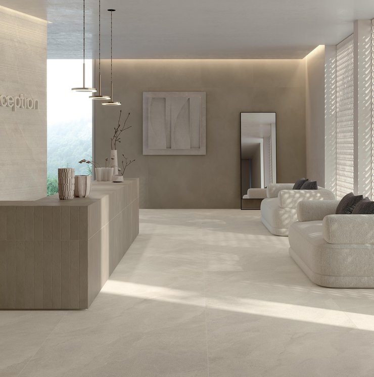 Réception moderne avec sol et murs effet pierre claire.