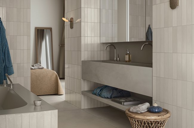 Minimal bathroom with light rectangular tiles and sink.